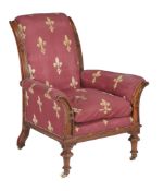 A Victorian walnut armchair, circa 1880, with padded back, arms and seat, with Gothic trefoil