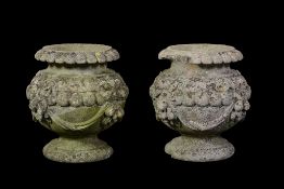 A pair of Victorian stone composition garden urns, almost certainly by Austin & Seeley, last