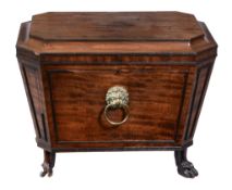 A Regency mahogany cellaret, circa 1815, of sarcophagus form, the hinged lid enclosing a lead lined