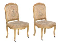 A pair of giltwood side chairs , early 20th century, each with earlier tapestry upholstery to the