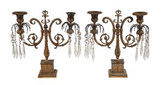 A pair of Regency gilt bronze twin light lustre candelabra, circa 1815, the urn sockets hung around