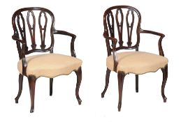 A matched pair of George III mahogany open armchairs , circa 1800, each in French Hepplewhite