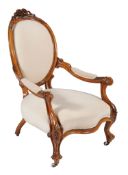 A Victorian carved walnut and white calico upholstered salon chair , circa 1860
