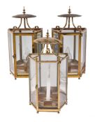 A pair of brass and glazed wall lanterns in early 19th century taste, 20th century, each with a