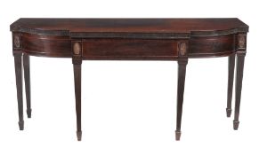 A Regency mahogany breakfront serving table, circa 1815, the frieze incorporating three drawers,