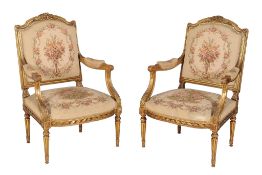 A pair of giltwood armchairs in Louis XVI style, early 20th century, each with machined needlepoint