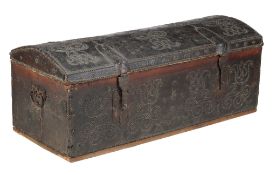 A brass studded leather chest, first half 18th century, the studding forming tulip motifs, flanked