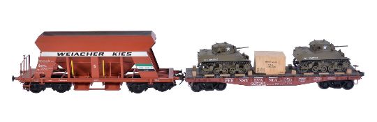 A gauge 1 low loading transportation wagon, in American livery transporting two military tanks and