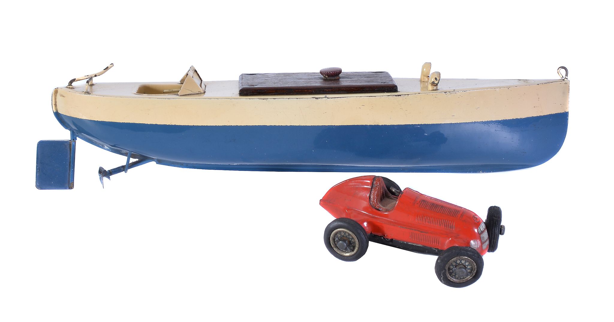 A model of a Sutcliffe clockwork toy motor boat, circa 1934 and a Shuco studio toy racing car.