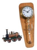 A brass cased pressure gauge converted to clock, and a model of an early 2-2-2 locomotive 'North