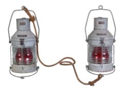 A matched pair of galvanise finished ships lamps, having formed wire carrying handles. Height 61cm.