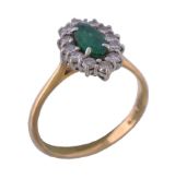 An emerald and diamond ring, the central marquise cut emerald claw set within a surround of