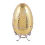 A hammered silver gilt surprise Easter egg by David Rhys Mills, London 2001, opening to reveal a