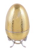 A hammered silver gilt surprise Easter egg by David Rhys Mills, London 2001, opening to reveal a