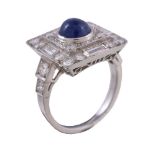 A sapphire and diamond panel ring, the squared panel set with a central circular cabochon sapphire