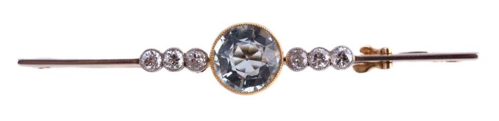 An Edwardian diamond and aquamarine bar brooch, circa 1910, the circular cut aquamarine between