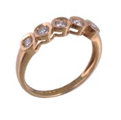 An 18 carat gold diamond five stone ring, the brilliant cut diamonds within a polished gold coloured