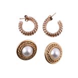 A pair of hooped earrings, the curved tubogas hoops, stamped with 9 carat gold import marks, with