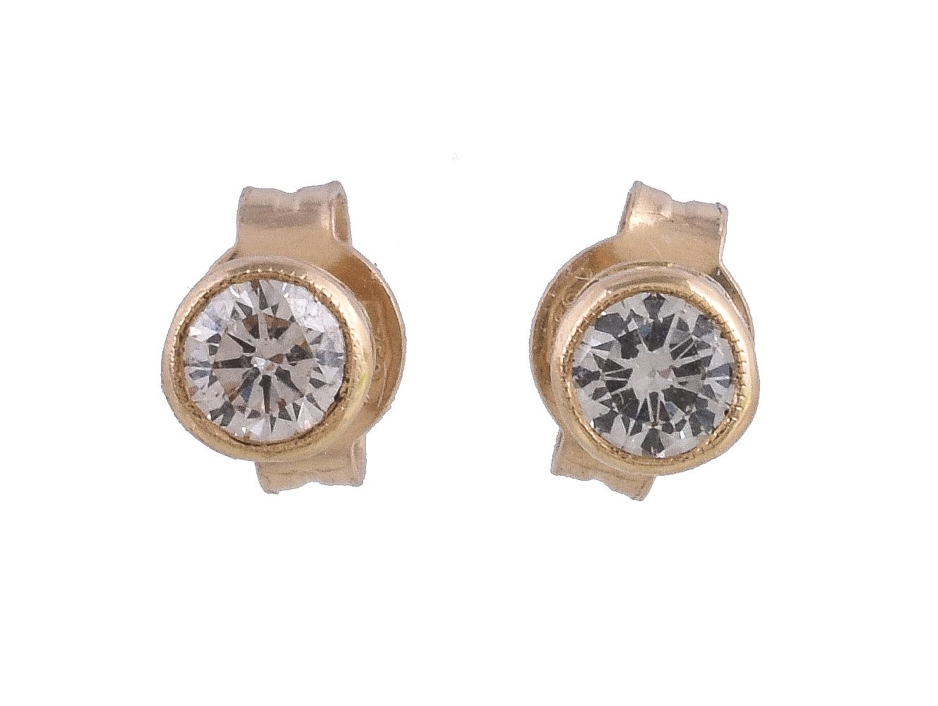 A pair of diamond ear studs, the brilliant cut diamonds within a gold coloured collet surround,