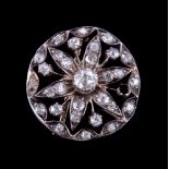 A late Victorian diamond brooch, circa 1890, the circular openwork brooch set with old cut diamonds,