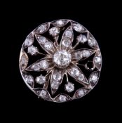 A late Victorian diamond brooch, circa 1890, the circular openwork brooch set with old cut diamonds,