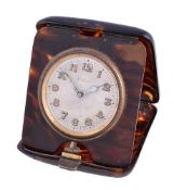 A faux tortoiseshell travelling desk clock, Swiss three quarter plate 8 day movement, silvered dial,