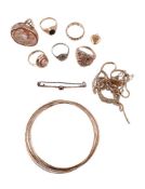 A small collection of 9 carat gold jewellery, to include seven 9 carat gold bangles; a textured