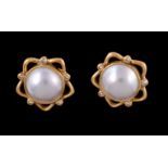 A pair of mabé pearl and diamond earrings, the circular mabé pearls within a pierced star shaped