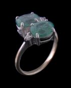 An 18 carat green tourmaline and diamond ring, the two green tourmalines in a crossover design