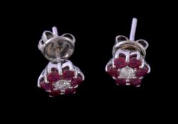 A pair of ruby and diamond cluster ear studs, the central brilliant cut diamonds, approximately 0.24