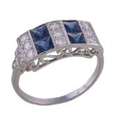 A diamond and sapphire panel ring, the rectangular panel with alternating rows of brilliant cut