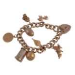 A 9 carat gold curb link charm bracelet, the curb link bracelet, with suspended charms, including