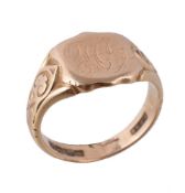 An 18 carat gold signet ring, the shield shaped panel to scrolled shoulders, hallmarked Birmingham