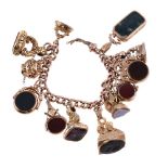 A 9 carat gold fob and charm bracelet, the curb link bracelet suspending various hardstone fobs, and
