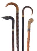 Four horn mounted walking sticks, all late 19th or early 20th century, the first handle carved as