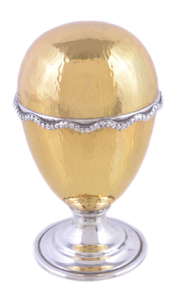 A hammered silver parcel gilt surprise Easter egg by David Rhys Mills, London 1996, opening to