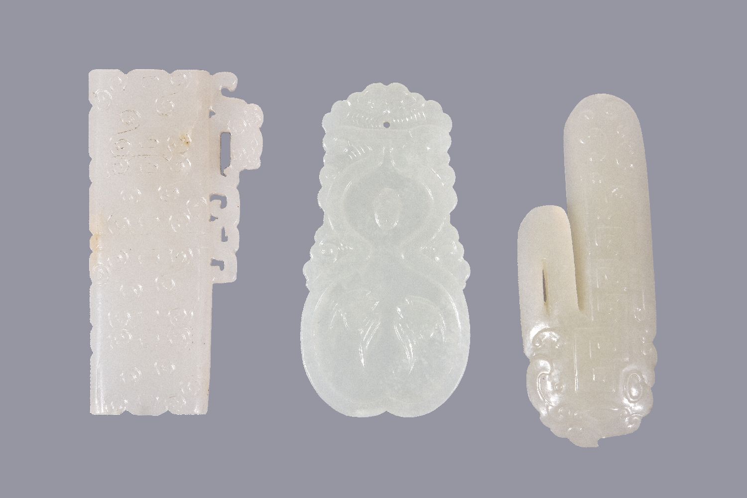Three Chinese white jade archaistic carvings, the pale even stones with some mottled white