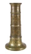 A Safavid brass candlestick, Persia, 17th century and later, of faceted columnar form, the flared