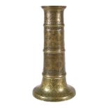 A Safavid brass candlestick, Persia, 17th century and later, of faceted columnar form, the flared