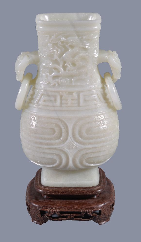 A Chinese white jade vase, hu, the pear-shaped vessel quartered on each side by high strapwork