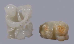 A Chinese white jade of man, holding a brocade ball above a Buddhist lion, 4.2cm high x 3.2cm wide x