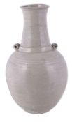 A Chinese white glazed bottle vase, Yuan Dynasty, the ovoid body with twin lug handles and everted