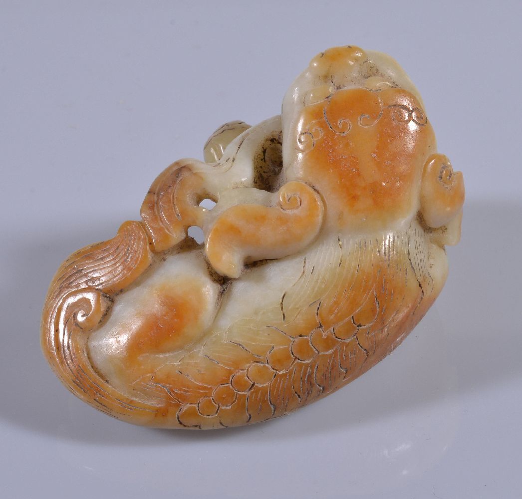 A Chinese white and russet jade Buddhist lion, with incised details, the mouth slightly opened - Image 2 of 4