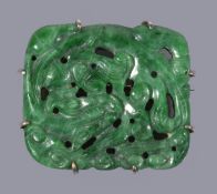 A Chinese green jadeite brooch, the openwork rectangular panel carved with a coiled dragon, jade