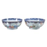 A pair of Chinese Famille Rose bowls, Qianlong, each painted to the exterior with two large panels