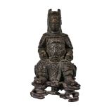 A small Chinese bronze of military official, seated, Ming or Qing Dynasty, on fitted pierced