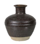 A Chinese brown-glazed vase, Song Dynasty, of ribbed ovoid form with flared neck, 15cm high