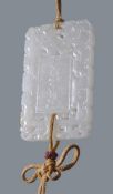 A Chinese white jade 'abstinence' plaque, the pendant is carved and pierced on each side with two
