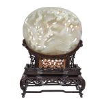 A Chinese white or pale celadon jade Yuan-style oval 'lotus and goose' plaque, carved in openwork