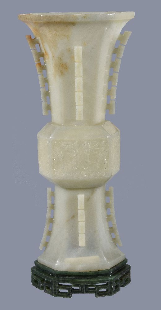 A Chinese celadon jade gu-shaped octagonal vase, with russet inclusions around part of the neck,